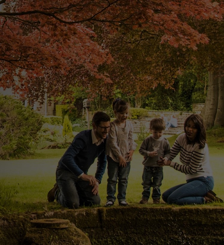 Family sat together in garden