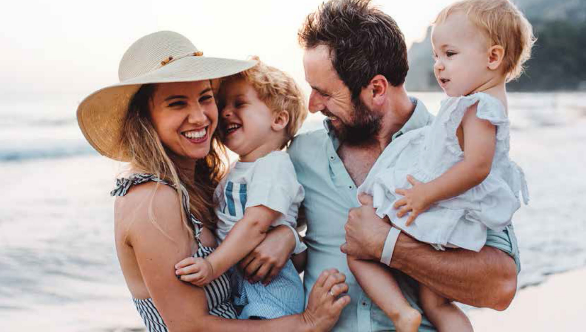 A happy family having fun time at the beach