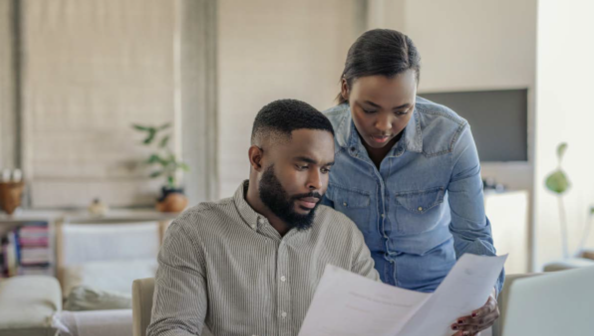 Image of couple reviewing their spending to maintain financial security.