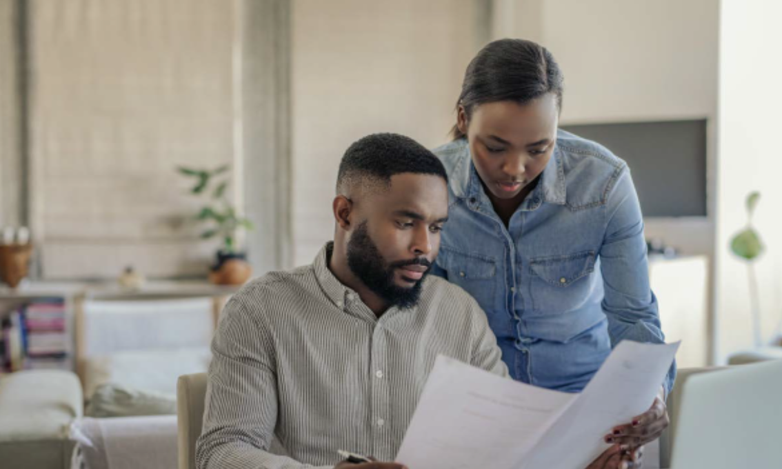 Image of couple reviewing their spending to maintain financial security.