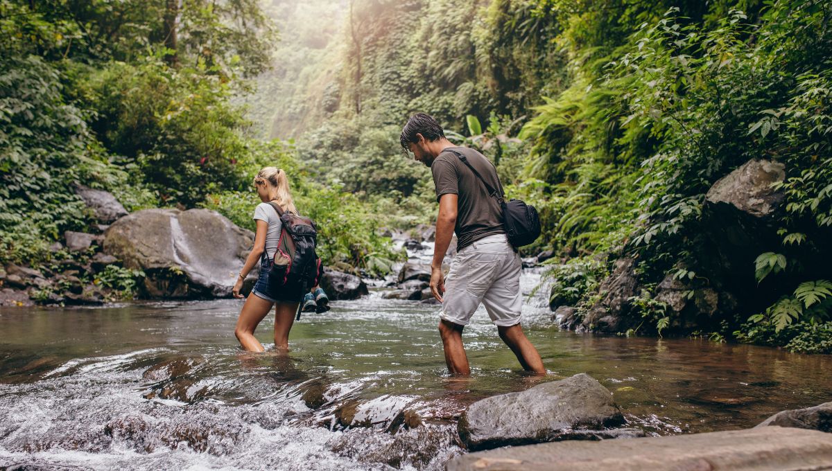 Couple walking across a stream